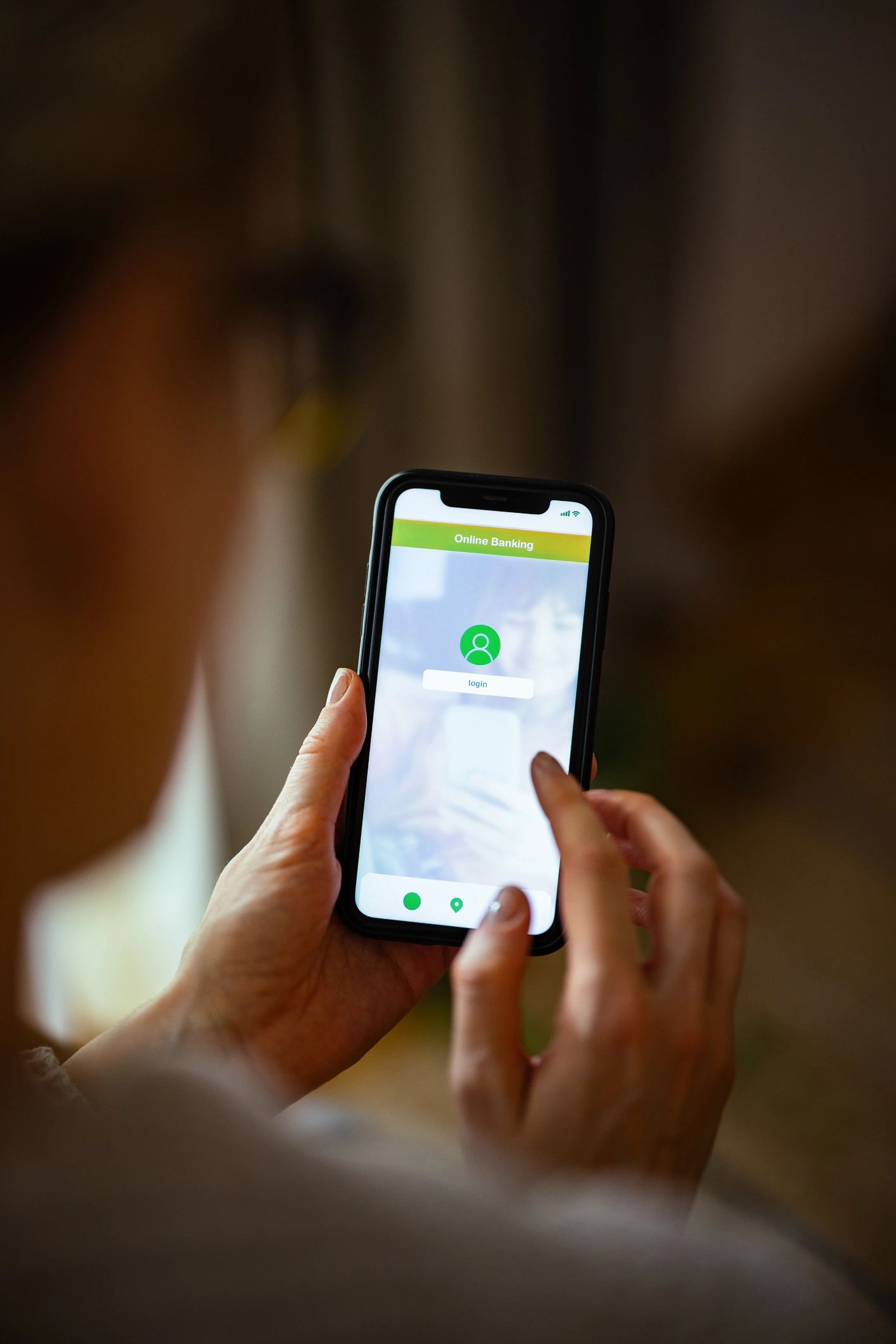 Hands holding a smartphone on a login screen representing secure account access
