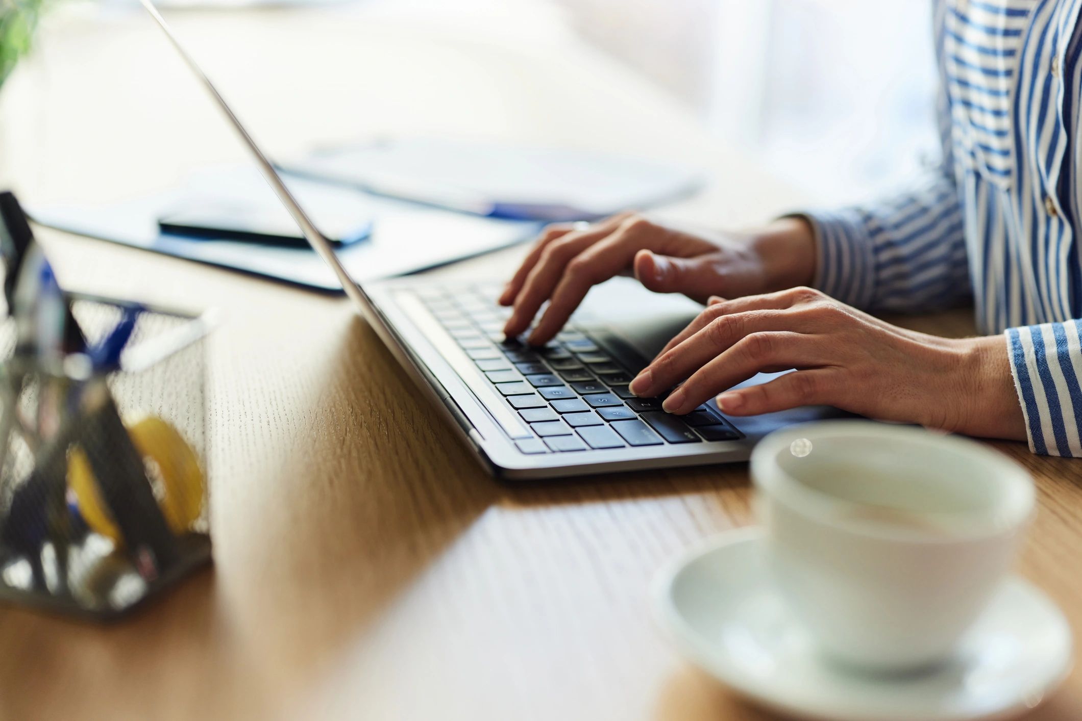 Person using a laptop representing account privacy and security